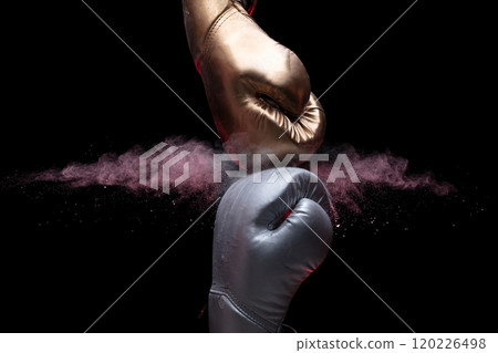 Two Boxing Glove in silver and gold punch hit together. Business challenge fighting concept. Smoke dust powder explode at back, black background isolated Two Boxing Glove in silver and gold punch hit together. Business challenge fighting concept. Smoke dust powder explode at back, black background isolated 120226498