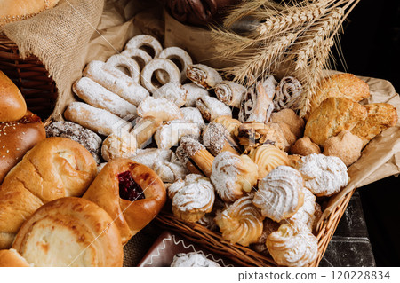 Assorted traditional pastries and cookies with powdered sugar, perfect for festive gatherings 120228834