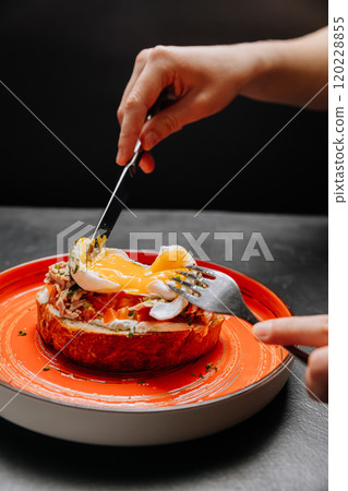 Delicious open-faced sandwich with poached egg and tuna on crispy bread, perfect brunch inspiration Delicious open-faced sandwich with poached egg and tuna on crispy bread, perfect brunch inspiration 120228855