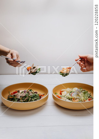 Two fresh salads with unique toppings, perfect for a light and healthy shared meal Two fresh salads with unique toppings, perfect for a light and healthy shared meal 120228858
