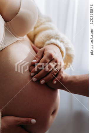 Gentle hands on a baby bump, celebrating love, connection, and the journey to parenthood Gentle hands on a baby bump, celebrating love, connection, and the journey to parenthood 120228878