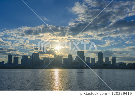 The skyscrapers and sunrise in Umeda, Osaka, seen across the Yodo River 120229419