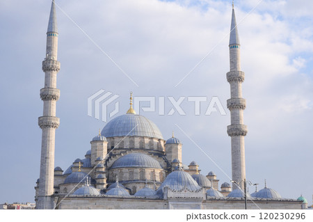 A Majestic Mosque Featuring Towering Minarets and Stunning Domes Under a Cloudy Sky A Majestic Mosque Featuring Towering Minarets and Stunning Domes Under a Cloudy Sky 120230296