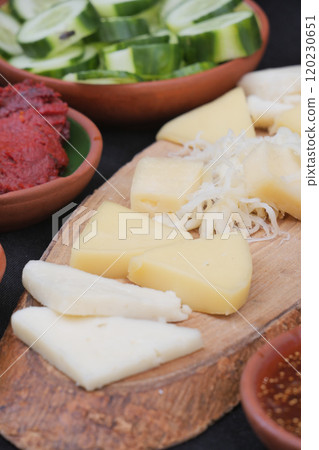A delightful variety of Fresh Cheeses and Accompaniments beautifully presented on a Wooden Board A delightful variety of Fresh Cheeses and Accompaniments beautifully presented on a Wooden Board 120230651