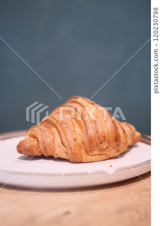 A Freshly Baked Croissant Placed Beautifully on a Plate Ready to Enjoy With Your Meal A Freshly Baked Croissant Placed Beautifully on a Plate Ready to Enjoy With Your Meal 120230798