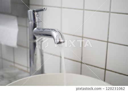 Fresh water is flowing gracefully from a sleek, shiny chrome faucet in a cozy kitchen setting, 120231062