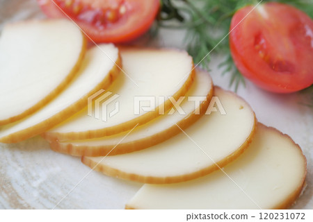 Sliced Cheese and Fresh Tomatoes Garnished with Herbs Sliced Cheese and Fresh Tomatoes Garnished with Herbs 120231072