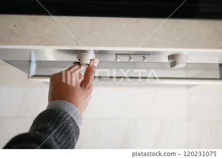 Close up of men hand setting temperature control on oven. Close up of men hand setting temperature control on oven. 120231075