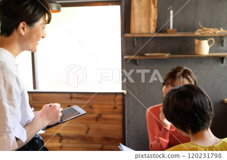 Owner taking orders at the cafe 120231798