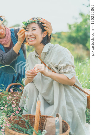 Flower picking activities, such as making flower crowns out of white clover 120233863