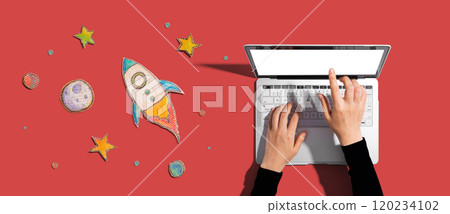 Space exploration theme with rocket and laptop 120234102