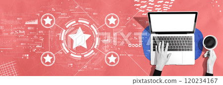Rating star concept with person using a laptop Rating star concept with person using a laptop 120234167