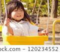 A girl playing with a swing 120234552