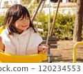 A girl playing with a swing 120234553