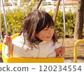 A girl playing with a swing 120234554