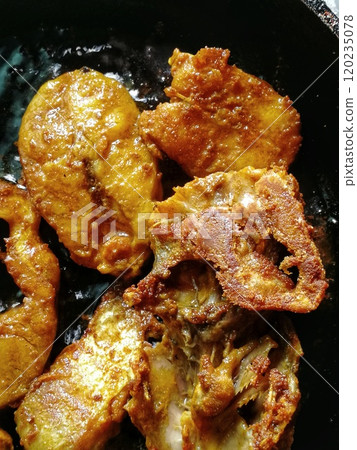 Making of fried fish steak with mixed spices. Most delicious food item in south India for any special occasion Making of fried fish steak with mixed spices. Most delicious food item in south India for any special occasion 120235078