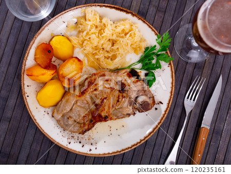 Pork served with pickled cabbage and potatoes 120235161