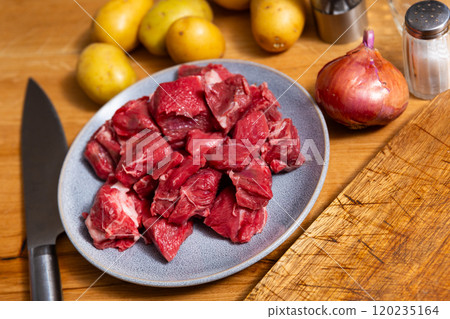Pieces of raw veal tenderloin and spices, onion, set of products for cooking baked and fried meat Pieces of raw veal tenderloin and spices, onion, set of products for cooking baked and fried meat 120235164
