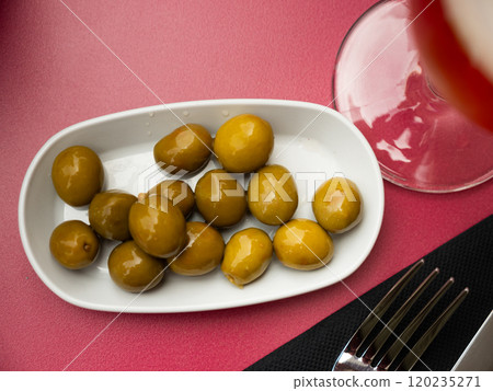 Spanish tapas from marinaded green olives at plate 120235271