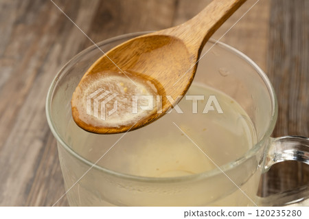 薑湯：用湯匙舀起薑湯。 120235280
