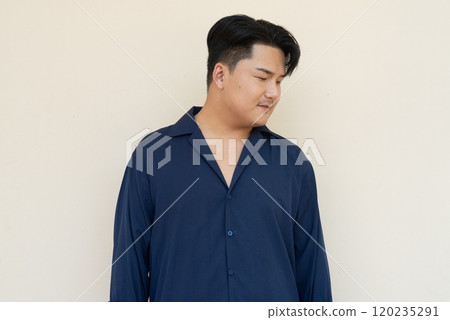 Portrait of Handsome Young Asian Man Against Plain Background Portrait of Handsome Young Asian Man Against Plain Background 120235291