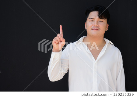 Portrait of Handsome Young Asian Man Against Black Background Portrait of Handsome Young Asian Man Against Black Background 120235329