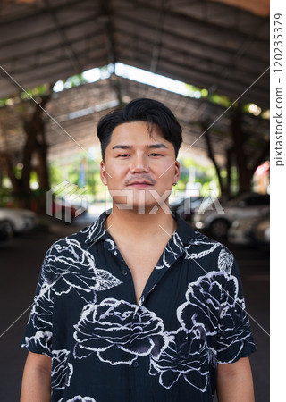 Portrait of Handsome Young Asian Man Outdoors in City 120235379