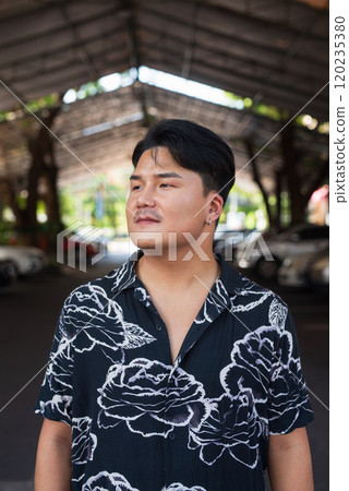 Portrait of Handsome Young Asian Man Outdoors in City 120235380