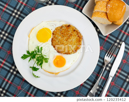 On plate are marrow squash pancakes with fried eggs On plate are marrow squash pancakes with fried eggs 120235412