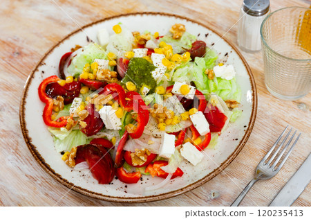 Vegetable salad with corn and bell peppers on a plate 120235413