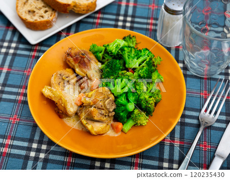 Pieces of chicken stewed in creamy sauce complemented with boiled broccoli. Pieces of chicken stewed in creamy sauce complemented with boiled broccoli. 120235430