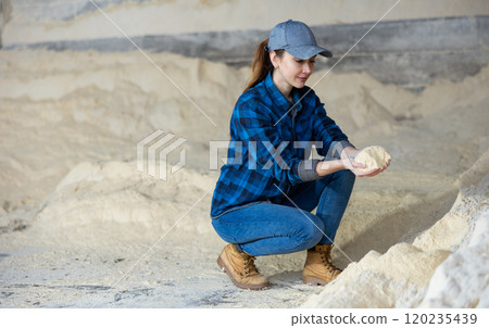 Woman farmer checking quality of maize flour Woman farmer checking quality of maize flour 120235439