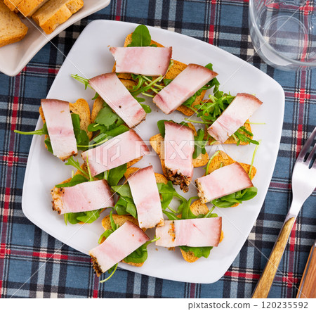 Toast with bacon and arugula for breakfast Toast with bacon and arugula for breakfast 120235592