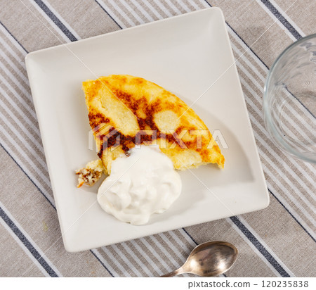 There is piece of casserole on plate, made from cottage cheese 120235838