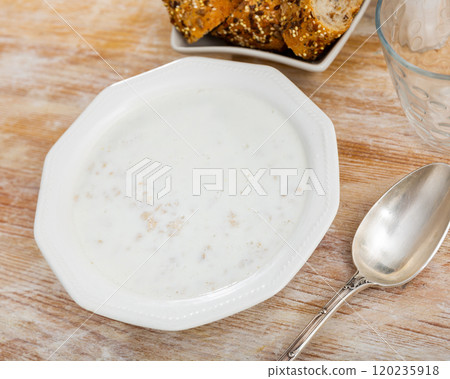 There is portion of freshly prepared milk oatmeal porridge in plate There is portion of freshly prepared milk oatmeal porridge in plate 120235918