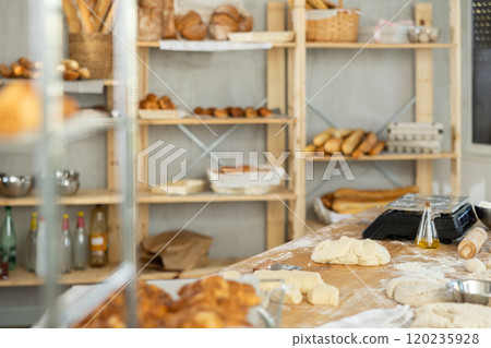Bakery kitchen interior - raw dough on table for making baguettes and croissants 120235928