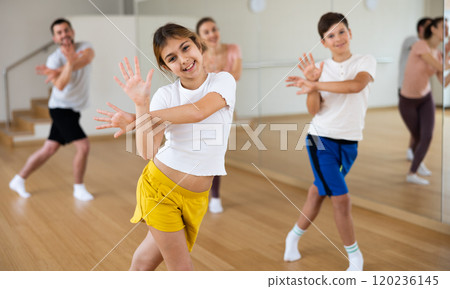 Girl exercising during family dance class 120236145