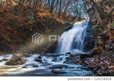 Asama Falls in autumn with sunlight streaming in 120238828
