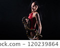 Image of brunette woman with blowing hair holding snake 120239864