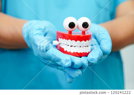 Funny red teeth with eye toy denture model for dental health care. 120241222