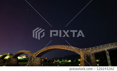 Arch bridge and shining constellations in the night sky Arch bridge and shining constellations in the night sky 120243202