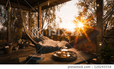 Golden autumn in a country house. Beautiful terrace in a private house. Golden autumn in a country house. Autumn sunset on the terrace. Hammock on the terrace 120243558