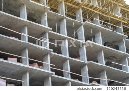 Stage of construction of a modern residential multi-storey building. Concrete monolith. Brick building under construction. Real estate. 120243836