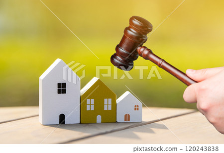 Wooden houses and judge's hammer. Real estate court decisions. Property inheritance litigation. Establishment of ownership. Wooden houses and judge's hammer. Real estate court decisions. Property inheritance litigation. Establishment of ownership. 120243838