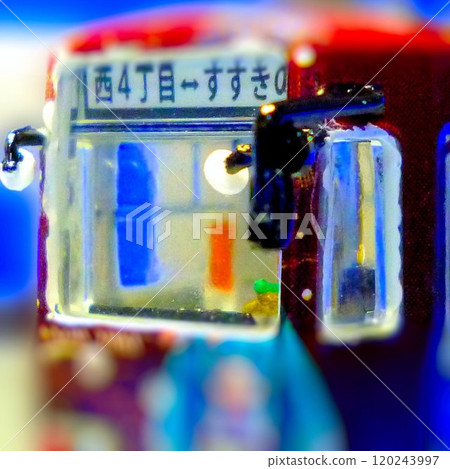 Painting the driver's cab of a model train 120243997