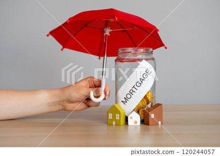 Bank of coins Mortgage, houses and red umbrella. Mortgage default insurance - Opportunity to buy a home with a down payment of less than 20%. Business and finance concept. 120244057