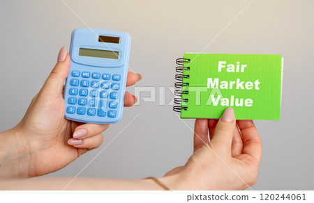 Fair Market Value concept. Price an asset would sell for on the open market when certain conditions are met. Business and finance. Calculator and notebook in hands 120244061