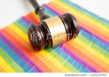 Gavel for judge lawyer on rainbow flag, symbol of LGBT pride month. 120245703