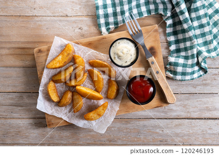 Fried potato wedges with sauces isolated on white background Fried potato wedges with sauces isolated on white background 120246193