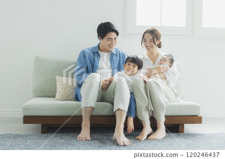 Young family, parents and children, living room 120246437
